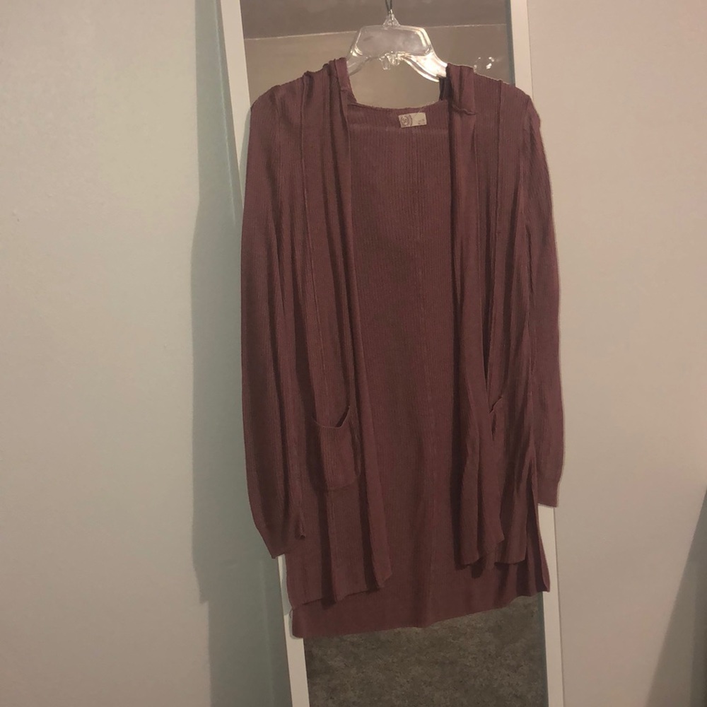 Rose gold sweater with pockets and hood.